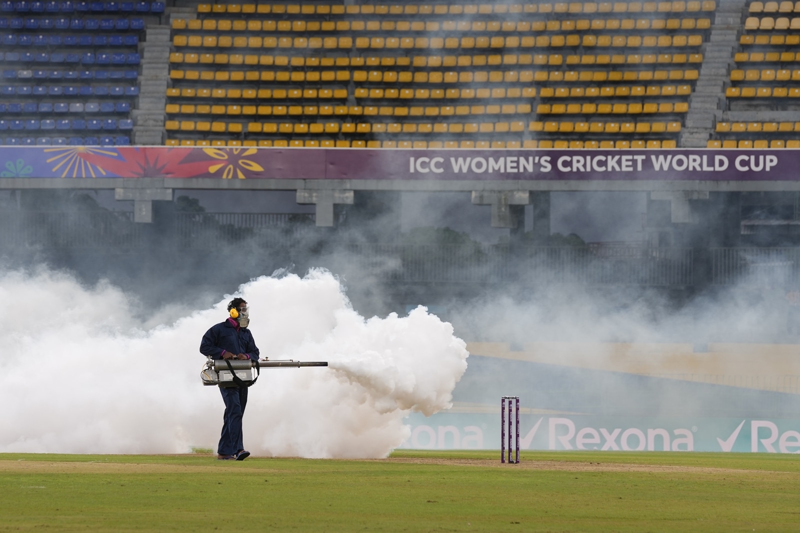 A worker fumigates the field during the ICC Women's Cricket World Cup match between India and Pakistan at Premadasa Stadium in Colombo. (AP Photo)