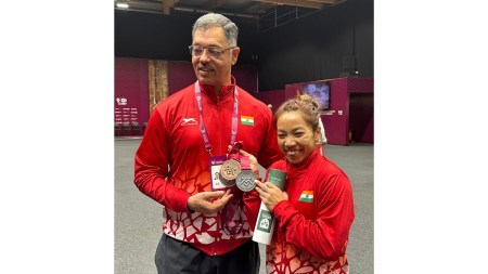 Mirabai Chanu and her coach Vijay Sharma with the World Championship medals. Mirabai won a bronze in snatch and silver overall. (Photo via Special Arrangement)