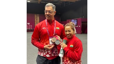 Mirabai Chanu and her coach Vijay Sharma with the World Championship medals. Mirabai won a bronze in snatch and silver overall. (Photo via Special Arrangement)
