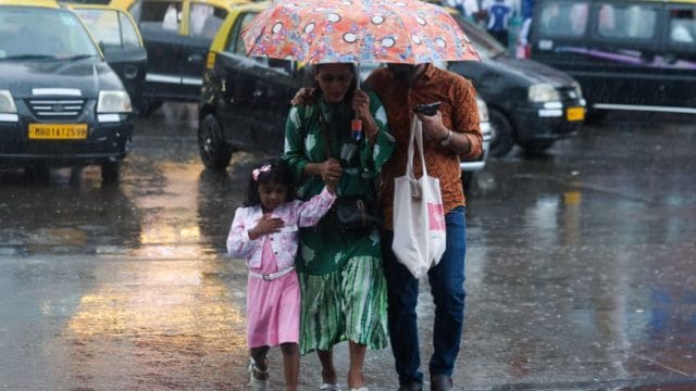 Rain lashes Dadar in Mumbai, with dark clouds hovering over the city. Express photos by Akash patil
