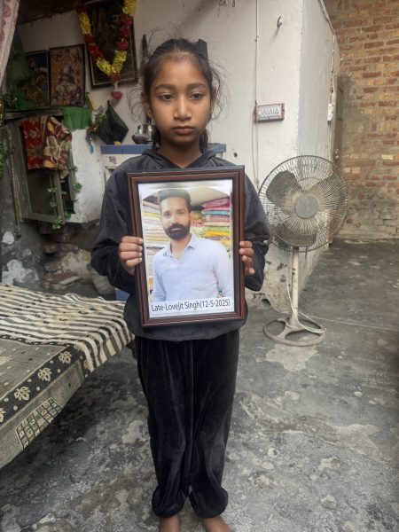 Lovepreet’s daughter with his photo. (Express Photo)