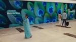 The newly unveiled peacock-themed barricade at Apple Noida, set to open on December 11 at DLF Mall of India. (Image: Apple)