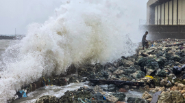Ramanathapuram: A man stands on rocks as waves crash against the seaside during rough sea conditions triggered by Cyclone Ditwah, in Ramanathapuram, Tamil Nadu, Friday, Nov. 28.