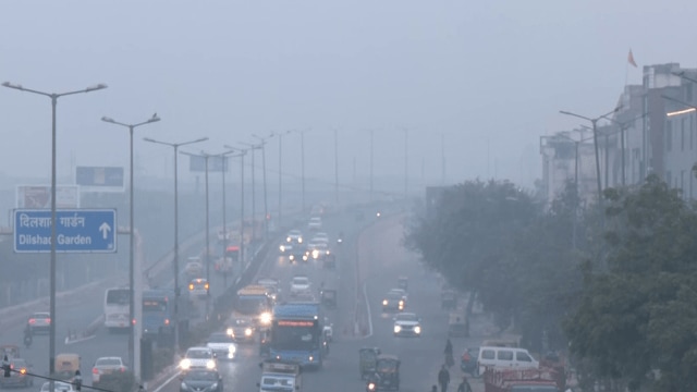 Vehicles ply under dense smog as the Air Quality Index (AQI) reaches severe category at Punjabi Bagh, in New Delhi on Thursday.