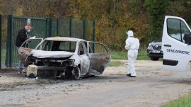Investigators inspect the burned car after a motorist deliberately rammed pedestrians and cyclists across two neighbouring towns on the Ile d'Oleron, a quiet French island popular with tourists off the Atlantic coast, Wednesday, Nov. 5, 2025. (AP Photo/Yohan Bonnet)