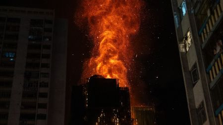 Flames engulf a building after a fire broke out at Wang Fuk Court, a residential estate in the Tai Po district of Hong Kong's New Territories, Wednesday, Nov. 26 2025. (AP Photo/Chan Long Hei)