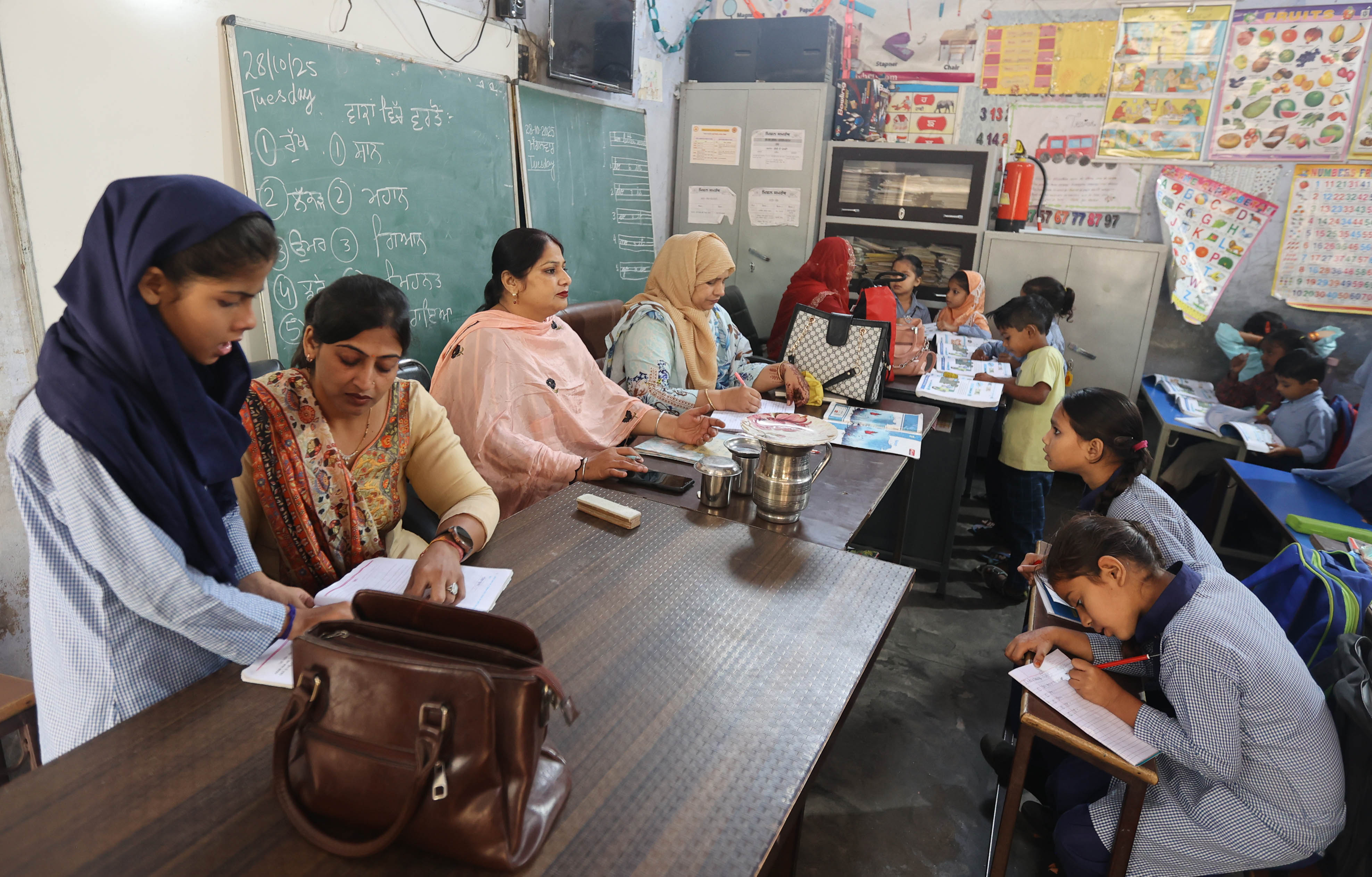  Four teachers attending children from three classes at government primary school, Malerkotla. Teachers say they don’t even get elbow space (Express photo by Gurmeet Singh)