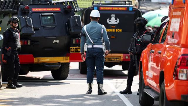 Armed police personnel and military personel guard near an area after an explosion occurred at a school complex in Jakarta, Indonesia (REUTERS)