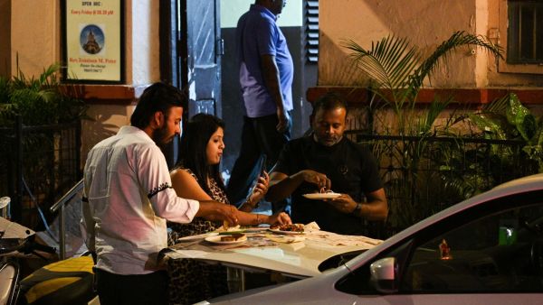 At Bademiyan, servers often turn car bonnets into makeshift tables using a plastic bottle. Express photo by Sankhadeep Banerjee