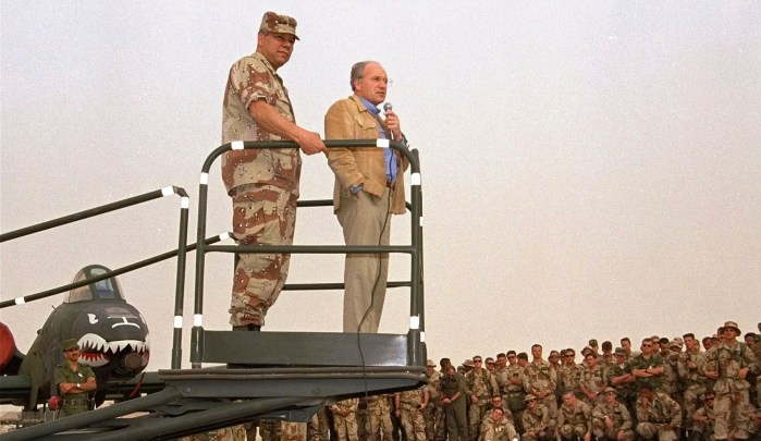 FILE - Secretary of Defense Dick Cheney, right, and Gen. Colin Powell, chairman of the Joint Chiefs of Staff, speak to members of the 354th Tactical Fighter Wing from Myrtle Beach, S.C. at their air base in Saudi Arabia, July 18, 1991. (AP Photo/Bob Daugherty, File)