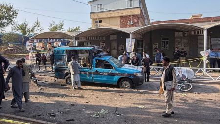 Security officials examine a damage vehicle at the site following a suicide bombing outside the gates of a district court, in Islamabad, Pakistan, Tuesday, Nov. 11, 2025. AP/PTI
