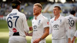 England's captain Ben Stokes, second left, shakes hands with teammate Shoaib Bashir as he leaves the field after losing the first Ashes cricket test match against Australia in Perth, Saturday, Nov. 22, 2025.(AP Photo/Gary Day)