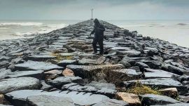 A man walks along the shore amid rough sea conditions due to Cyclone Ditwah, in Tiruchirappalli, Tamil Nadu, Sunday, Nov. 30, 2025. (PTI Photo)