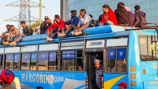 Commuters board a private bus, a day after a strike by PRTC contractual workers over detainment of their leaders by police, at a bus stand, in Patiala, Punjab. (PTI Photo)