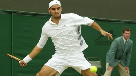 Switzerland's Roger Federer plays a return to Sjeng Schalken, of the Netherlands, during their men's singles quarter final match at the All England Lawn Tennis Championships at Wimbledon, July 3, 2003. (AP Photo)