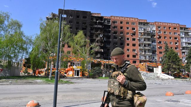 A Ukrainian soldier walks past damaged buildings in central Pokrovsk, in the Donetsk region of Ukraine, April 23, 2025. (AP Photo/Michael Shtekel, File)