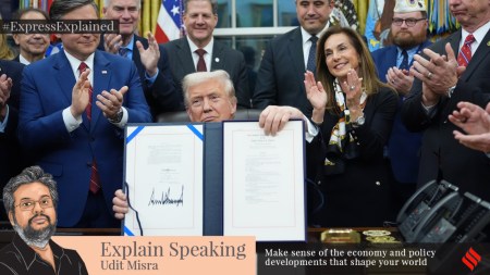 US President Donald Trump displays the signed funding bill to reopen the government, in the Oval Office of the White House, Wednesday, Nov. 12.