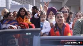 World Cup winner Amanjot Kaur and Harleen Kaur Deol along with family members at Mohali airport. (Express photo by Jasbir Malhi)