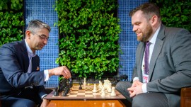 India's first individual Olympic medallist Abhinav Bindra sits across a chess board from FIDE Secretary General Lukasz Turlej after making the ceremonial first move at the FIDE World Cup final. (PHOTO: Michal Walusza via FIDE)