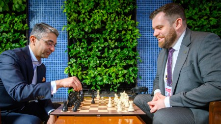 India's first individual Olympic medallist Abhinav Bindra sits across a chess board from FIDE Secretary General Lukasz Turlej after making the ceremonial first move at the FIDE World Cup final. (PHOTO: Michal Walusza via FIDE)