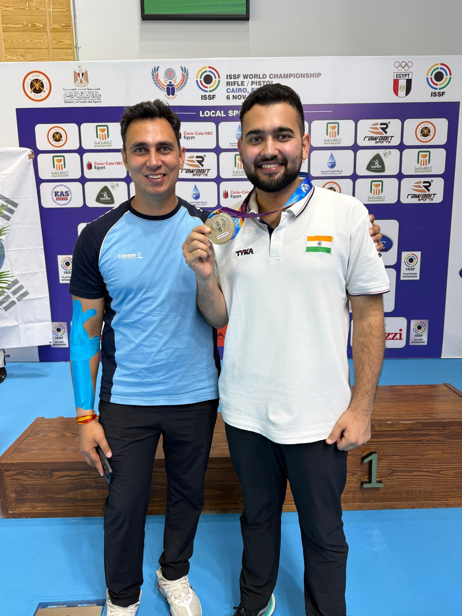 Anish Bhanwala with national coach Ankush Bhardwaj after winning the silver medal in the ISSF World Championships in Cairo. (Image via Special Arrangement)