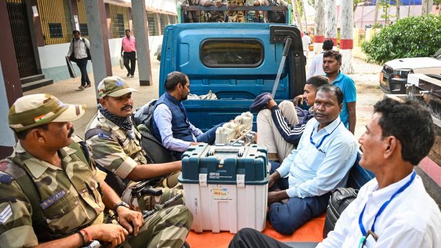 Polling officials carrying EVMs and other election material (PTI Photo)