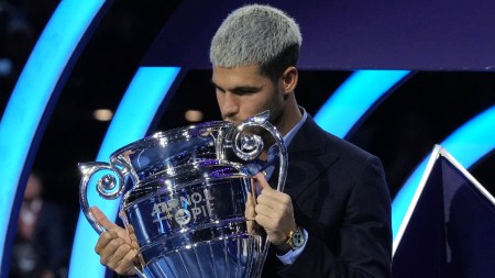 Spain's Carlos Alcaraz holds the trophy for finishing the year ranked No. 1 as ATP world best player during the ATP World Tour Finals, in Turin, Italy, Friday, Nov. 14, 2025. (AP Photo)