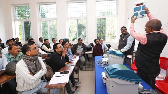 An election official briefs to vote counting staff during a training session