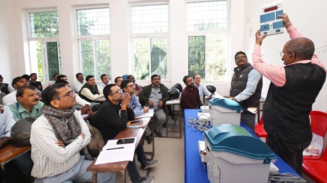 An election official briefs to vote counting staff during a training session