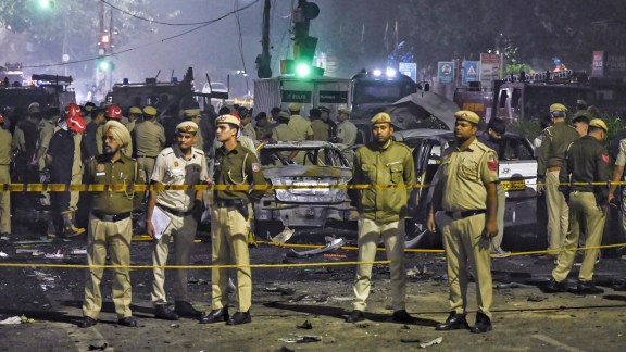 Police personnel at the site after a blast in a parked car near Red Fort left multiple vehicles in flames, in New Delhi