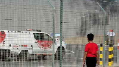 A bystander watches as an Indian HAL Tejas crashes during a demonstration at the Dubai Air Show, at Al Maktoum International Airport at Dubai World Central, Dubai, United Arab Emirates, Friday Nov. 21, 2025. (AP Photo/Jon Gambrell)