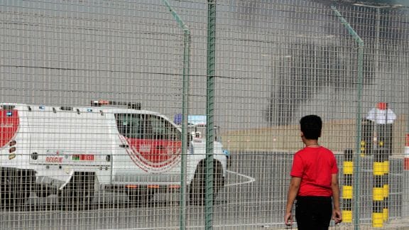 A bystander watches as an Indian HAL Tejas crashes during a demonstration at the Dubai Air Show, at Al Maktoum International Airport at Dubai World Central, Dubai, United Arab Emirates, Friday Nov. 21, 2025. (AP Photo/Jon Gambrell)