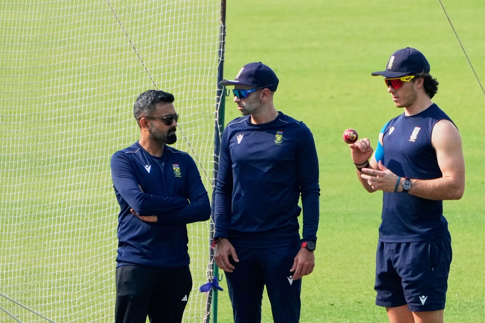 Dewal Brevis, right and Kesav Maharaj talk with a support staff during a practice session ahead of the first Test. (AP Photo)