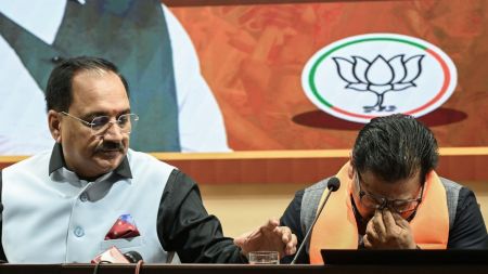 Delhi BJP state president Virendra Sachdeva offers water to Former Aam Aadmi Party MLA Rajesh Gupta as he gets emotional while joining the BJP, in New Delhi on Saturday.