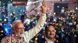 Prime Minister Narendra Modi waves a ‘gamcha’ as he arrives during the celebration of NDA’s victory in the Bihar Assembly elections, at BJP headquarters, in New Delhi