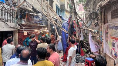 Residents stand in an alley after vacating their house next to a fallen scaffolding following an earthquake in Dhaka, Bangladesh, November 21, 2025. REUTERS