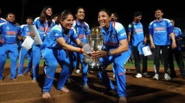 Renuka Singh Thakur (left) with other team members with the World Cup trophy