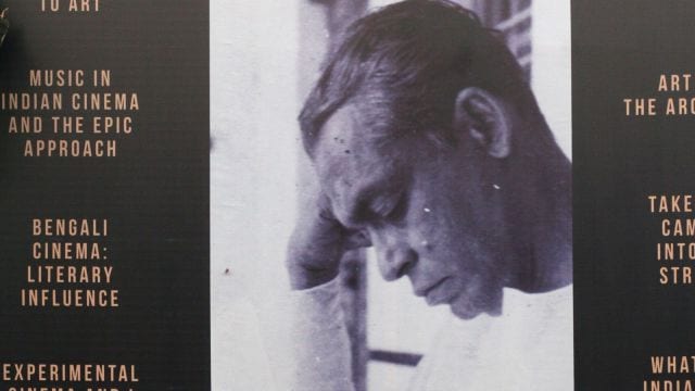 Book lovers are taking rest under a book stall which is carrying a portrait of Ritwik Ghatak, at International Kolkata Book Fair. Express Photo by Partha Paul. Kolkata. 05.02.2016.