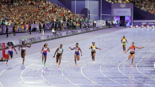 Julien Alfred, of Saint Lucia, 4th left, crosses the finish line ahead of Sha'carri Richardson, of the United States, and Melissa Jefferson, of the United States, to win the women's 100 meters final at the 2024 Summer Olympics, Saturday, Aug. 3, 2024, in Saint-Denis, France. (AP Photo)