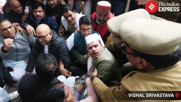 With the march halted, Ajay Rai and other Congress leaders sit on the road and stage a sit-in protest