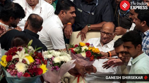 Well-wishers present floral bouquets and garlands to Pawar,