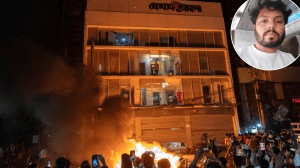 A crowd early on Friday gathers near the office of Prothom Alo newspaper in Dhaka, which was set on fire by angry protesters. (Photo: Reuters)