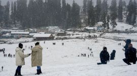 Tourists visit a snow-covered valley amid fresh snowfall on the first day of Chillai Kalan, in Gulmarg, Jammu and Kashmir, Sunday, Dec. 21, 2025. PTI