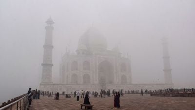 The Taj Mahal is barely visible in the morning these days due to the dense fog cover across North India (Photo: PTI).