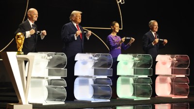(Left to right) FIFA President Gianni Infantino, US President Donald Trump, Mexican President Claudia Sheinbaum and Canadian Prime Minister Mark Carney smile during the draw for the 2026 soccer World Cup at the Kennedy Center in Washington, Friday, Dec. 5, 2025. (Dan Mullan/Pool Photo via AP)