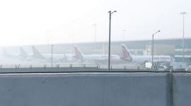 Planes parked at the IGI Airport in Delhi amid dense fog on Sunday (Photo: ANI).