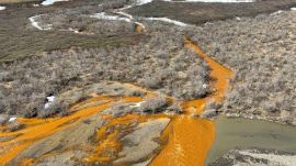 In an image provided by the USGS, A tributary of the Kugaaruk River in northern Alaska turning orange from elevated heavy metal concentrations. Record-setting temperatures and rainfall in the Arctic over 2025 sped up the melting of permafrost and washed toxic minerals into more than 200 rivers across northern Alaska, threatening vital salmon runs, according to a report card issued by federal scientists. (Image: The New York Times)