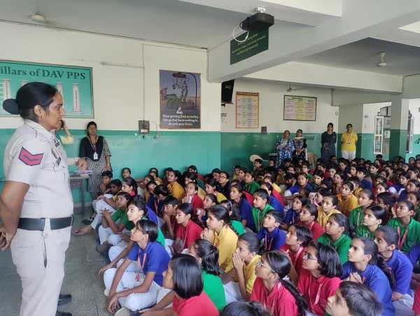 One of the members of the Women Safety Cell interacting with school girls. 