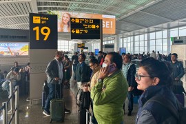 Passengers wait outside the Indira Gandhi International Airport in New Delhi, India, as several Indigo Airlines flights were either cancelled or delayed, Thursday, Dec. 4, 2025. (AP Photo/Manish Swarup)