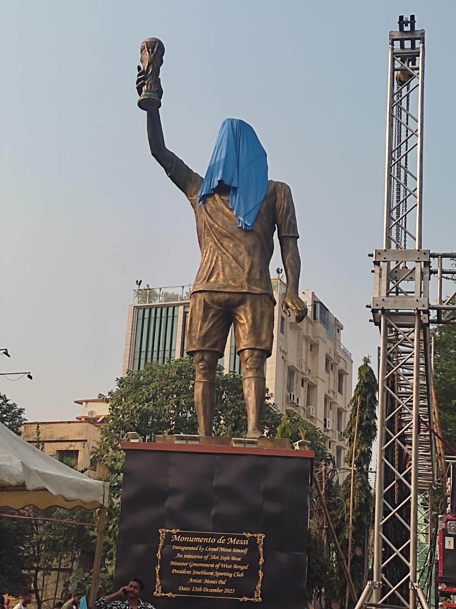 The 70 ft Lionel Messi statue with its face covered in Lake town on Friday. (Express Photo | Sayak Dutta)